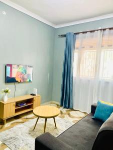 a living room with a couch and a table at Serenity homes Uganda in Mbale