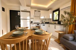 a kitchen and dining room with a table and chairs at Olivara Suites in Fethiye