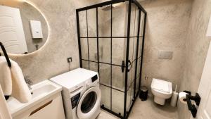 a bathroom with a washing machine and a toilet at Olivara Suites in Fethiye +13 photos