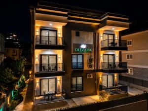 an external view of a hotel at night at Olivara Suites in Fethiye