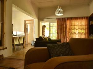 a living room with a couch and a table at Konka Guest Farm in Carnarvon