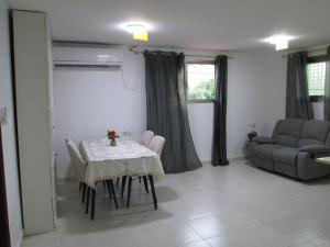a living room with a table and a couch at נוף יבנאל in Yavneʼel