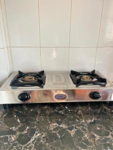 a stove in a kitchen with two burners on it at Serenity homes Uganda in Mbale +30 photos