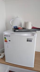a microwave sitting on top of a refrigerator at Ocean Breeze Inn in Eyemouth