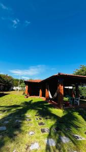 a house in a field with a grass yard at Pousada Brisa do Oceano - Cumbuco in Cumbuco