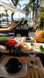 a table with plates of food on top at Villa Terang Bulan - luxury private beachfront villa in Pengastulan