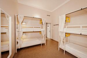 a room with three bunk beds in a room at Wombat's City Hostel Budapest in Budapest