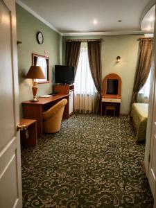 a hotel room with a bed and a desk at Old Town in Izmail