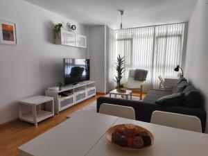 a living room with a couch and a tv at Piso en Cedeira in Cedeira +6 photos