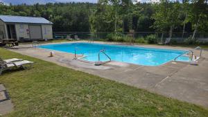 a large swimming pool with blue water in a yard at Big Green in Haverhill