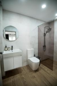 a bathroom with a toilet and a sink and a mirror at Incanto Rentals in Silistra +29 photos
