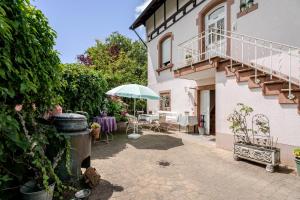 an outdoor patio with a table and an umbrella at Villa Rosa in Offenburg