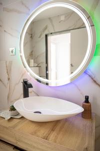a bathroom with a white sink and a mirror at Melissa's house in Amora +16 photos