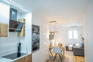 a kitchen and living room with a table and a couch at Melissa's house in Amora