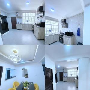 four different views of a kitchen with white cabinets at Jahi Luxe apartment in Gwarinpa