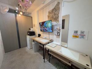 a room with a desk and a computer on the wall at 2 type room, Akira&chacha guest home杉並区世田谷direct to shinjuku for 13 min 上北沢3分 近涉谷新宿Suitable for three or more people in Tokyo