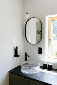 a bathroom with a sink and a mirror at OFF Living Charlet in Pirching am Traubenberg