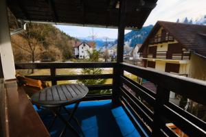 a chair sitting on a balcony with a view at Vila Residence in Moieciu de Sus