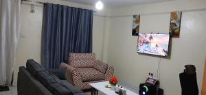 a living room with a couch and a chair at Urban Pulse Suites in Ruiru
