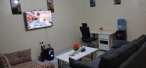 a living room with a couch and a table at Urban Pulse Suites in Ruiru