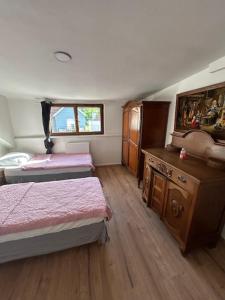 a small room with two beds and a wooden floor at myappart - FORBACH in Forbach