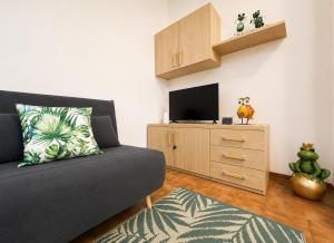 a living room with a couch and a tv at Bella Vita Stays Easy in Sondrio