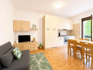 a living room with a couch and a table and a kitchen at Bella Vita Stays Easy in Sondrio