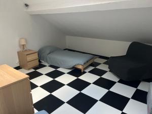 a small bedroom with a bed and a chair at Sporting Pyrenées House in Vicdessos +4 photos