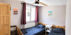 a bedroom with two beds and a window at Entre Mer et Montagnes in Céret