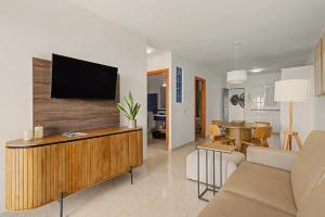 a living room with a flat screen tv on a wall at Callao Beach 3 in Arrieta