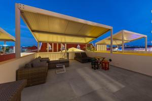 a patio with a couch and a table on a roof at Island Time Retreat in Willemstad