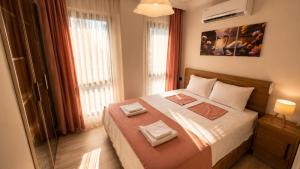 a bedroom with a bed with two towels on it at Olivara Suites in Fethiye