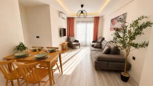 a living room with a table and a couch at Olivara Suites in Fethiye