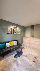 a living room with a black couch in a room at D House in Chernomorets
