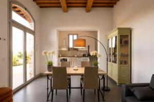 a kitchen and dining room with a table and chairs at Podere di Montecchio in Florence