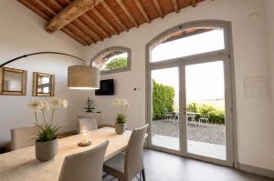 a dining room with a table and chairs and a window at Podere di Montecchio in Florence