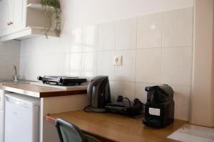 a kitchen counter with a appliance on top of it at Paradise Beach Apartments in Argassi +12 photos