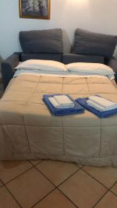 a large bed with two towels on top of it at A casa di nonna Elvira in Vietri sul Mare