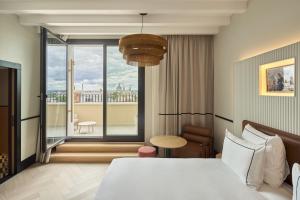 a hotel room with a bed and a large window at Urban Hive Madrid in Madrid +108 photos