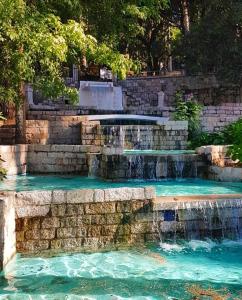 a waterfall in a pool with blue water at Al Vecchio Corso B&B in Tempio Pausania