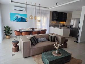 a living room with a couch and a kitchen at Villa Tedi in Podaca
