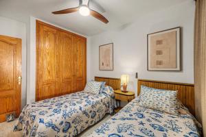 a bedroom with two beds and a ceiling fan at Callao Beach 1 in Arrieta