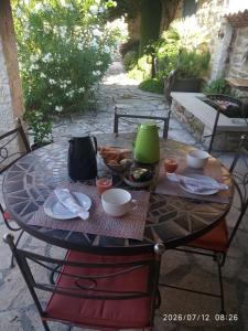 a table with food on it on a patio at Le Grangeon in Cruis
