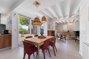a dining room and living room with a table and chairs at Ker Family in Arzon +19 photos