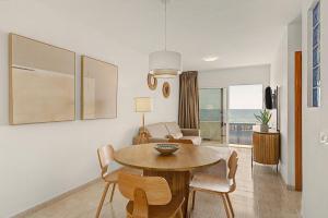 a living room with a table and chairs and a couch at Callao Beach 1 in Arrieta