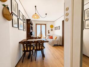 a living room with a table and chairs and a couch at Hostdomus - Villaggio Alpino in Sauze d'Oulx