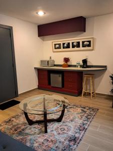 a kitchen with a glass table and a counter at Casa Puerto Siete8 in Mexico City