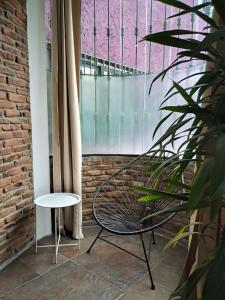 a chair and a table in front of a window at Casa Puerto Siete8 in Mexico City