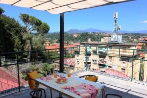 a table on a balcony with a view of a building at Glycine House in Varese