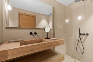 a bathroom with a wooden sink and a shower at La maison de simon in Pietrosella